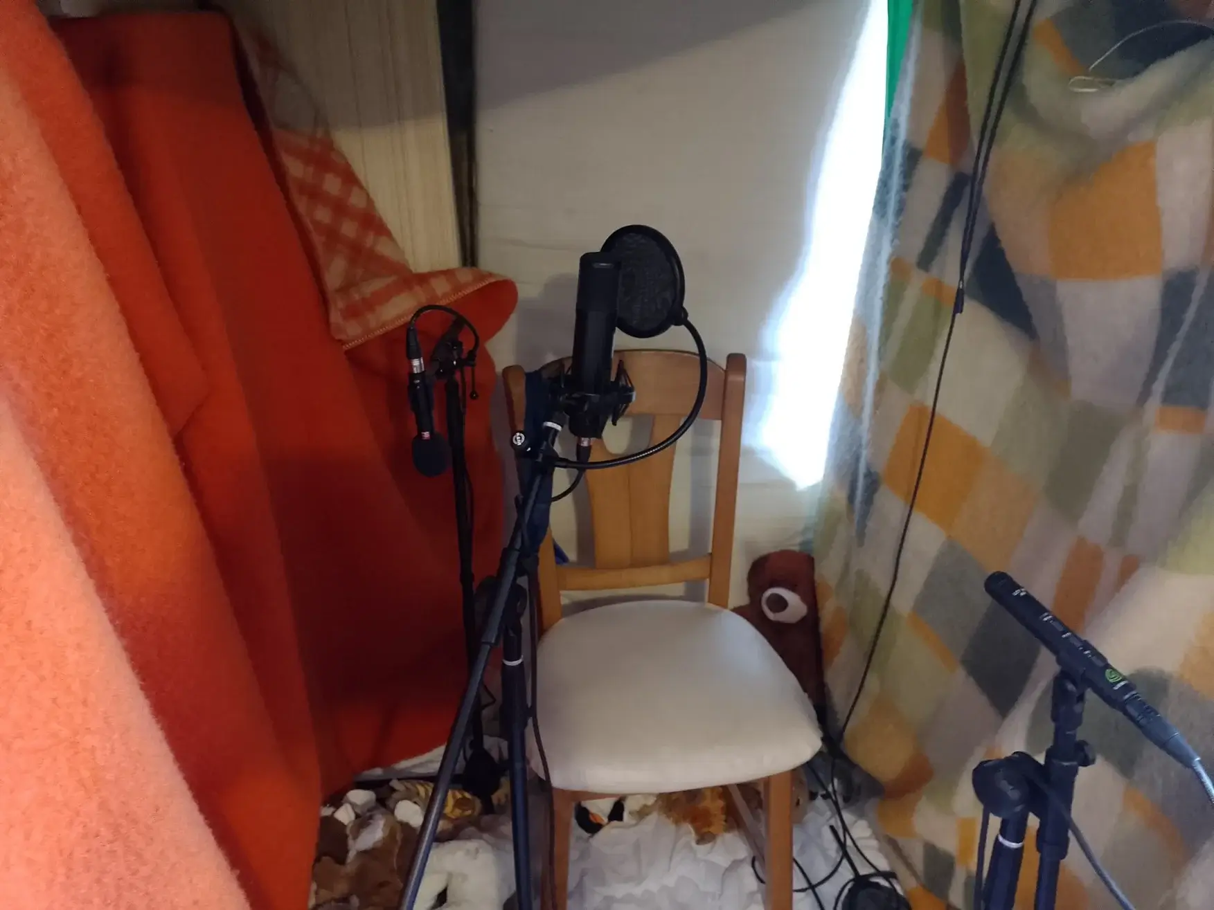 My improvised recording booth. Mattress at the back, thick blankets on either side, but the space behind mics is completely open.